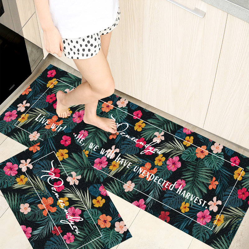 Woman standing on rectangular shaped home absorbent floor mats with flowers printed on it.