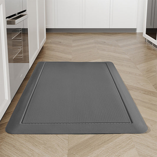 A gray anti-fatigue mat for a kitchen