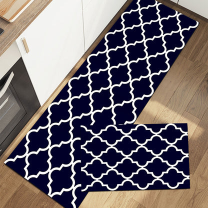 Rectangular rug with geometric pattern in dark green and white on wood floor