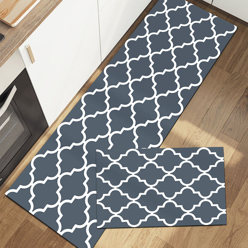 Rectangular rug with geometric pattern in gray blue and white on wood floor