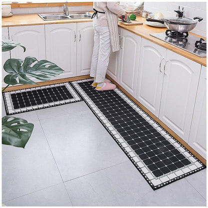 Woman standing on black and white mosaic coloured kitchen rug. 