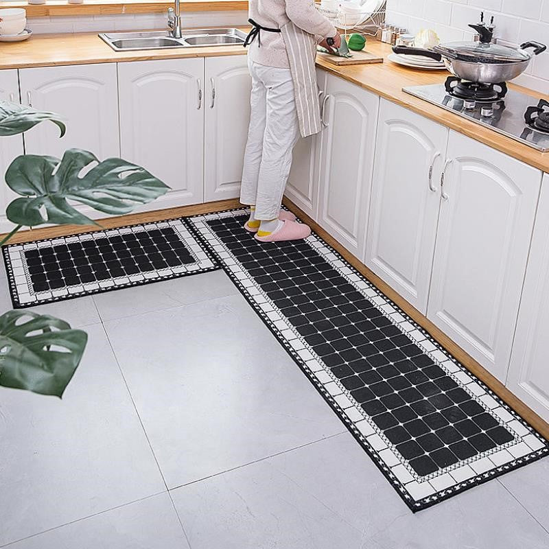 Woman standing on Anti Slip Kitchen Rugs Set printed with white and black coloured squares in a luxurious way.