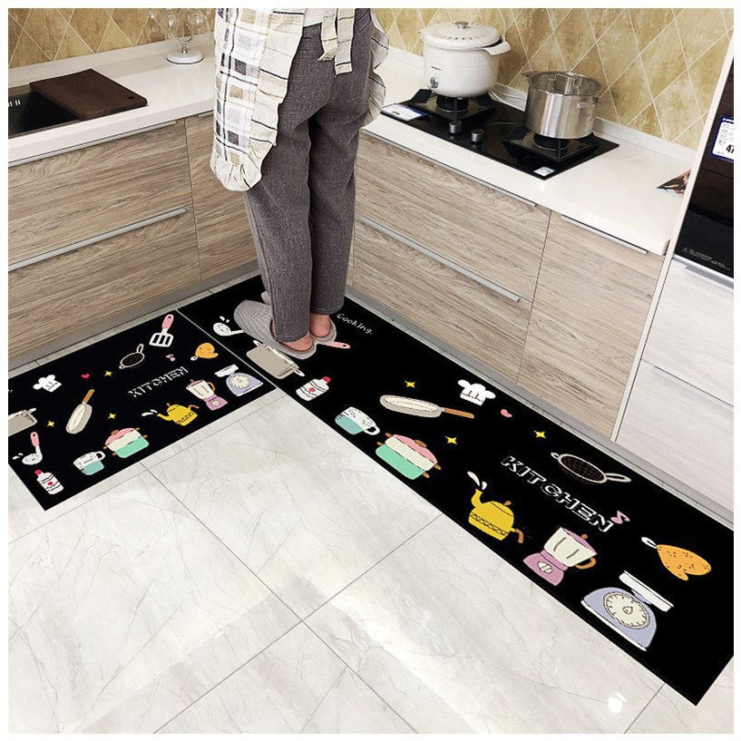 Woman standing on black coloured long oil-proof kitchen mats printed as warm kitchen style. 